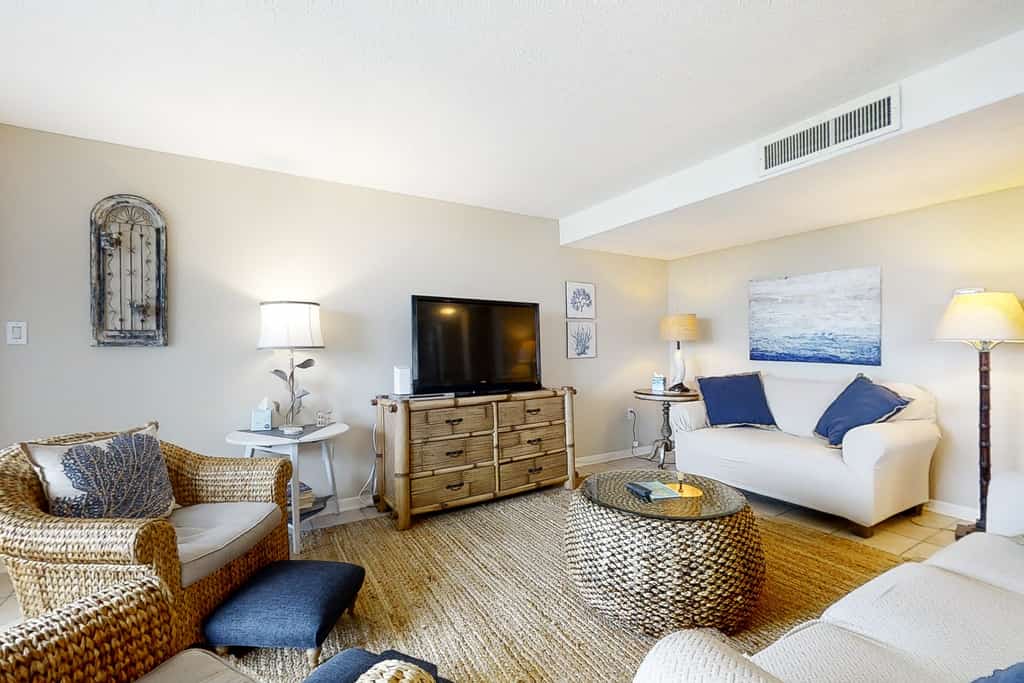 Renovated condo with balcony, lush views, outdoor pool