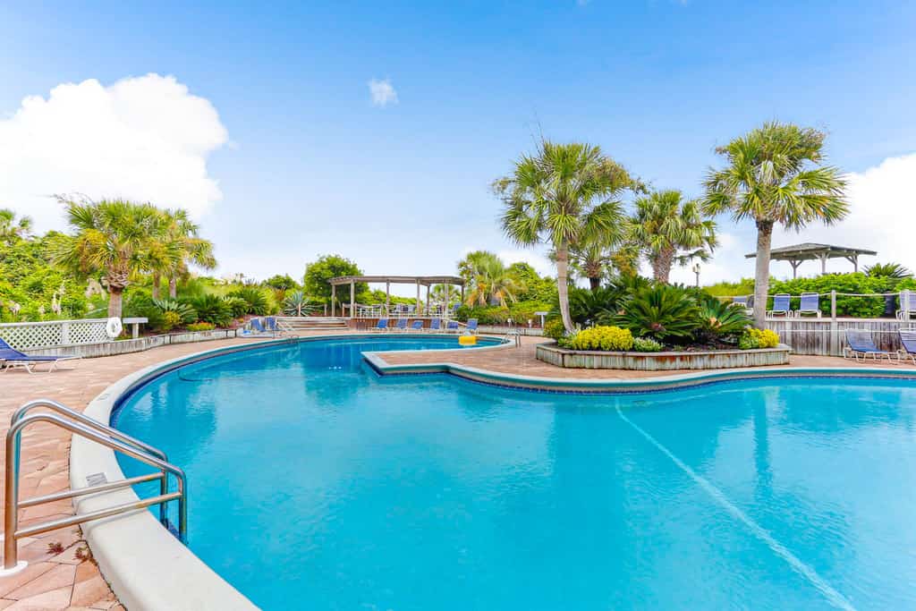 Renovated condo with balcony, lush views, outdoor pool