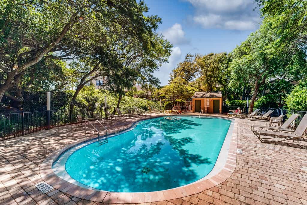 Oceanfront townhome with a furnished balcony, outdoor pool, & tennis