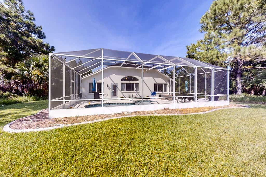 The Barefoot Bungalow | House in Palm Coast with an enclosed pool & grill