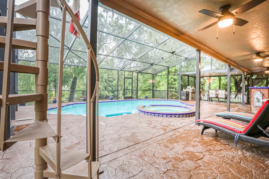 Riverfront retreat with pool spa outdoor kitchen firepit dock sauna and games