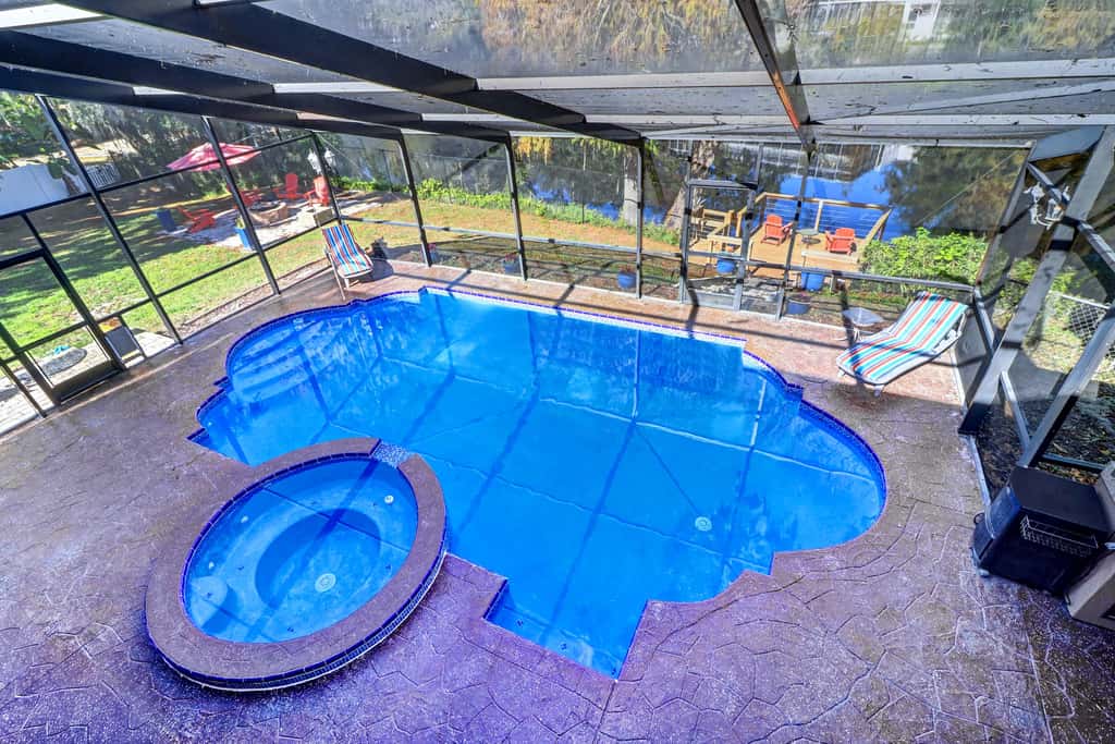 Riverfront retreat with pool spa outdoor kitchen firepit dock sauna and games