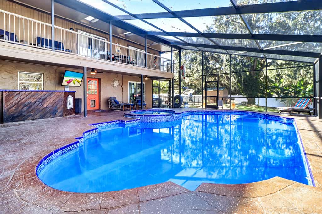 Riverfront retreat with pool spa outdoor kitchen firepit dock sauna and games