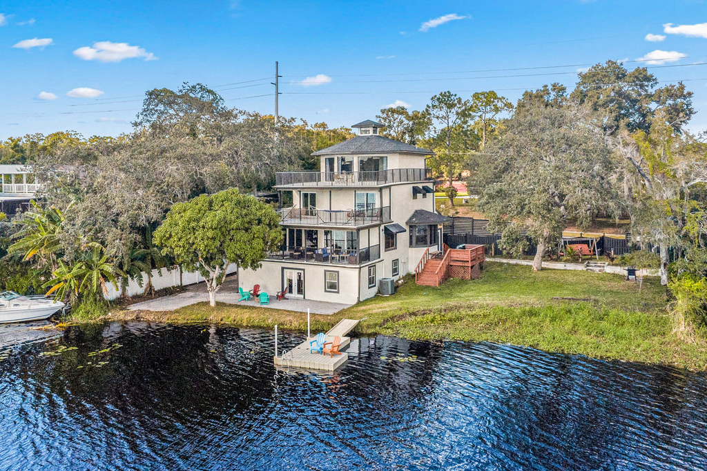 Sprawling river view estate with game room dock kayaks grill and fishing gear