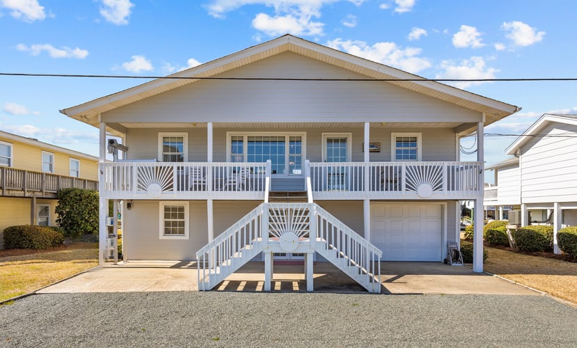Canal front home with a floating dock and large deck with sound views