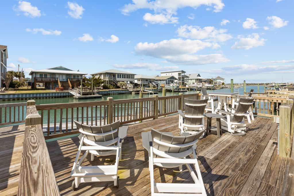 Canal front home with a floating dock and large deck with sound views
