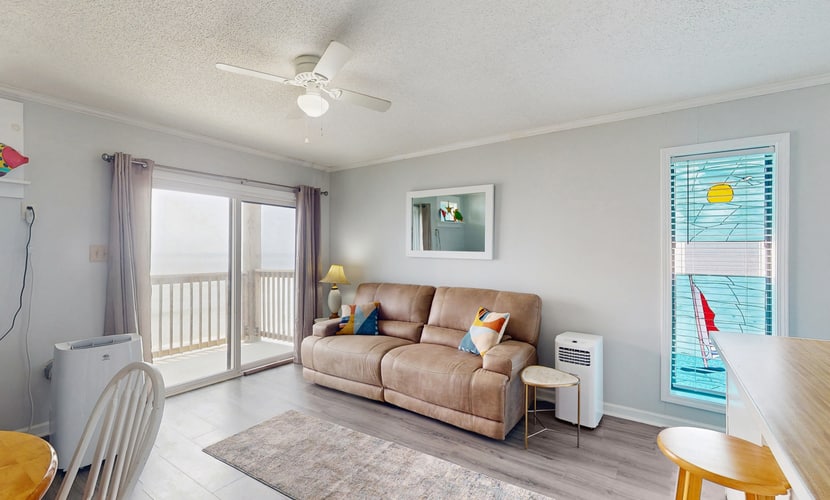 Beachfront condo with ocean views, balcony, WiFi, & shared grills