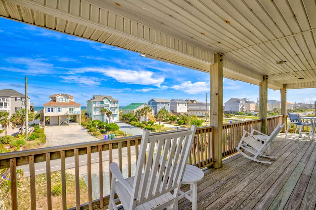 Ocean view home with a deck, washer/dryer, central AC, & gas fireplace