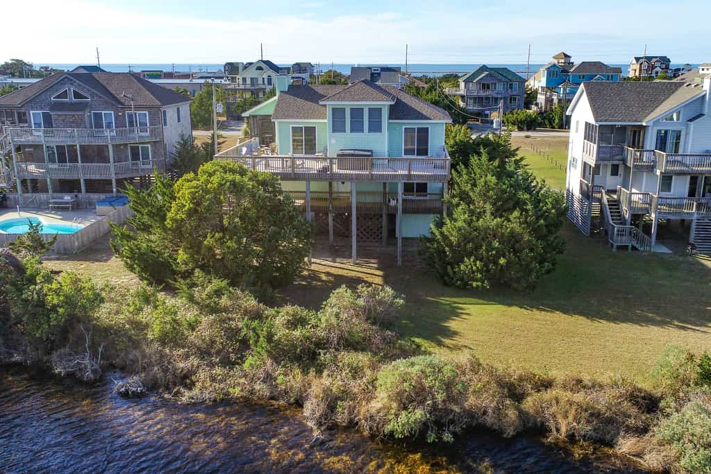 Home on private lake between beach & sound with WiFi, pool & hot tub