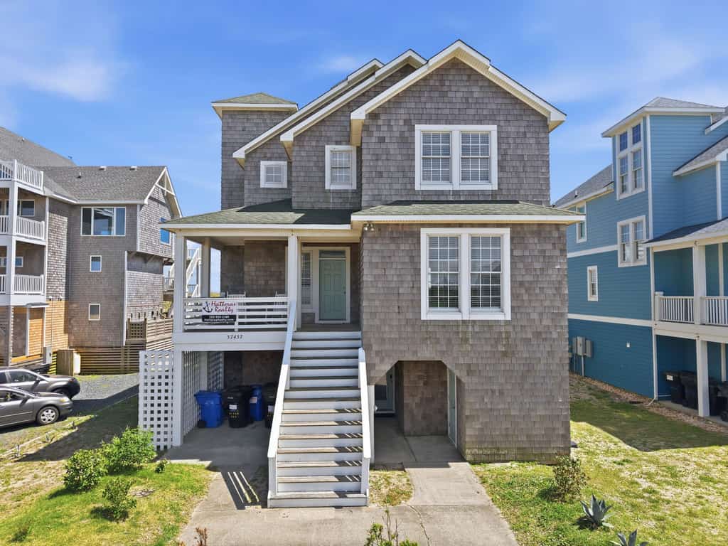 Three-story beachfront home with private pool, hot tub, decks, & ocean views