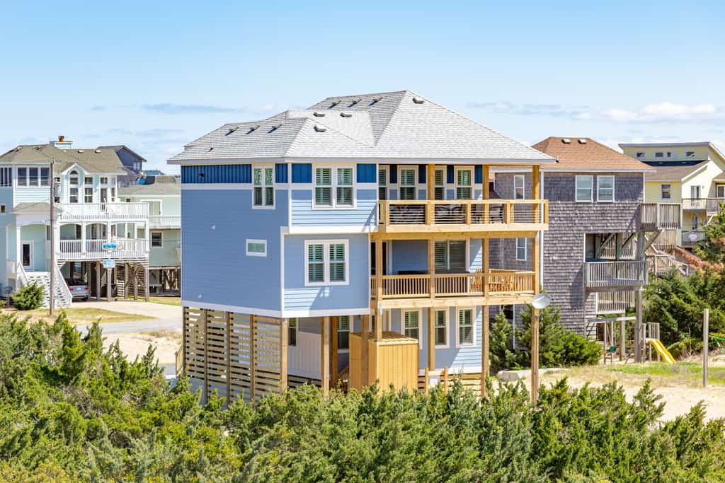 Grand beach home with elevator, private hot tub, game room, & pool access