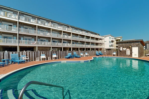 Inviting beachfront condo featuring hot tub & pool, central AC, elevator, & deck