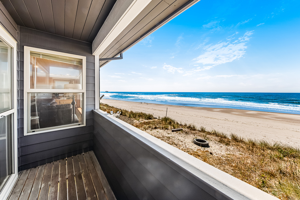 Two story oceanfront retreat with a washer dryer firepit and Ping Pong table