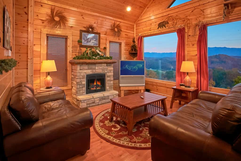 Unwind in mountain luxury at this cozy retreat in Legacy Mountain Resort, your perfect base to explore Sevierville, Pigeon Forge, and Gatlinburg. Enjoy breathtaking Smoky Mountain views from the deck, soak in your private hot tub, or relax by the electric fireplace. With a game room featuring a pool table, arcade, and card table, plus two living areas with Smart Roku TVs, a jacuzzi tub, a fully equipped kitchen, and pet-friendly comfort (fee applies), this cabin sleeps 8 in style.