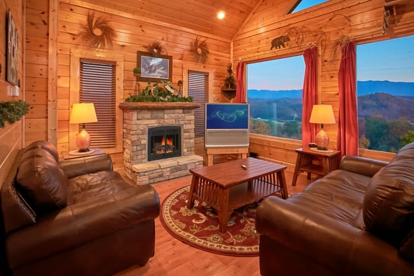 Unwind in mountain luxury at this cozy retreat in Legacy Mountain Resort, your perfect base to explore Sevierville, Pigeon Forge, and Gatlinburg. Enjoy breathtaking Smoky Mountain views from the deck, soak in your private hot tub, or relax by the electric fireplace. With a game room featuring a pool table, arcade, and card table, plus two living areas with Smart Roku TVs, a jacuzzi tub, a fully equipped kitchen, and pet-friendly comfort (fee applies), this cabin sleeps 8 in style.