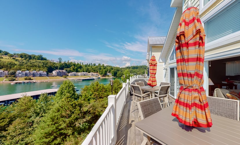 Spacious 4-bedroom vacation home in LaFollette, TN, overlooking Norris Lake and accommodating up to 12 guests. Enjoy a shared pool, baby pool, community dock, boat slip, full kitchen, wet bar, outdoor dining, and easy access to boating, fishing, kayaking, and East Tennessee attractions.