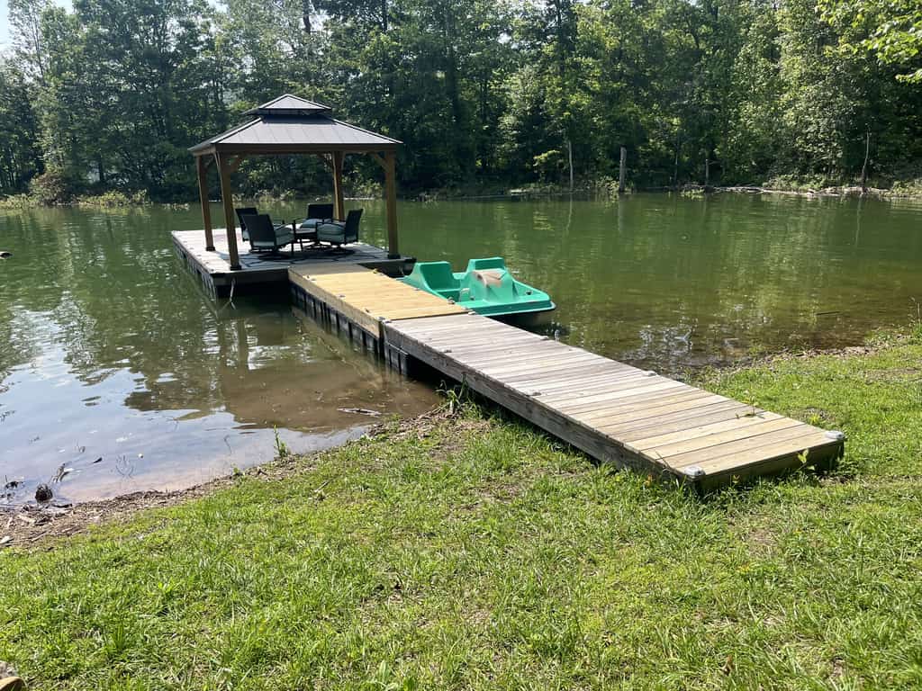 Escape to a lakefront Norris Lake cabin in Sharps Chapel, Tennessee, with 3 bedrooms, 2 bathrooms, a private seasonal dock with boat slip, covered deck, firepit, grill, smoker, and cozy fireplace. Perfect for family lake vacations, boating, fishing, and peaceful East Tennessee getaways.