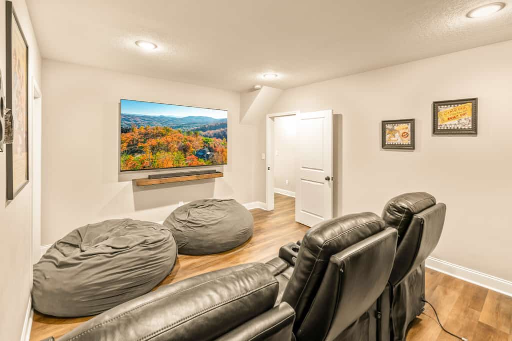 Shady Pines is a newly built Gatlinburg cabin in Cobbly Nob with scenic Smoky Mountain views and space for up to 12 guests. Enjoy three levels of comfort, expansive decks, a private hot tub, game room with pool table, air hockey and arcade games, plus a private theater. Guests also have access to seasonal community pools and Bent Creek Golf Course.