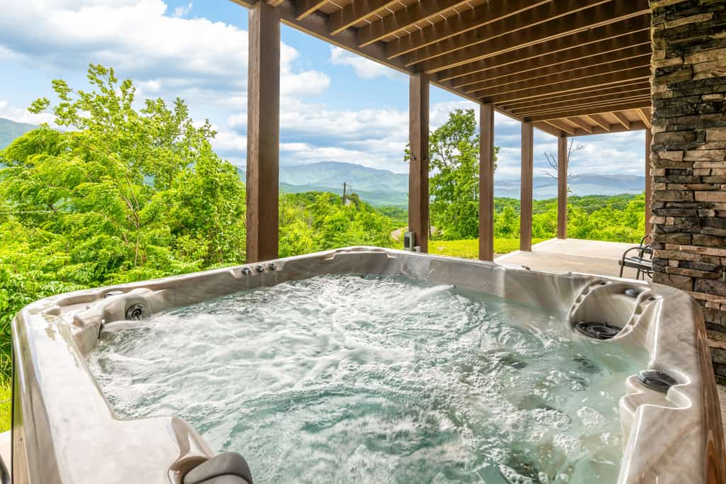 Shady Pines is a newly built Gatlinburg cabin in Cobbly Nob with scenic Smoky Mountain views and space for up to 12 guests. Enjoy three levels of comfort, expansive decks, a private hot tub, game room with pool table, air hockey and arcade games, plus a private theater. Guests also have access to seasonal community pools and Bent Creek Golf Course.