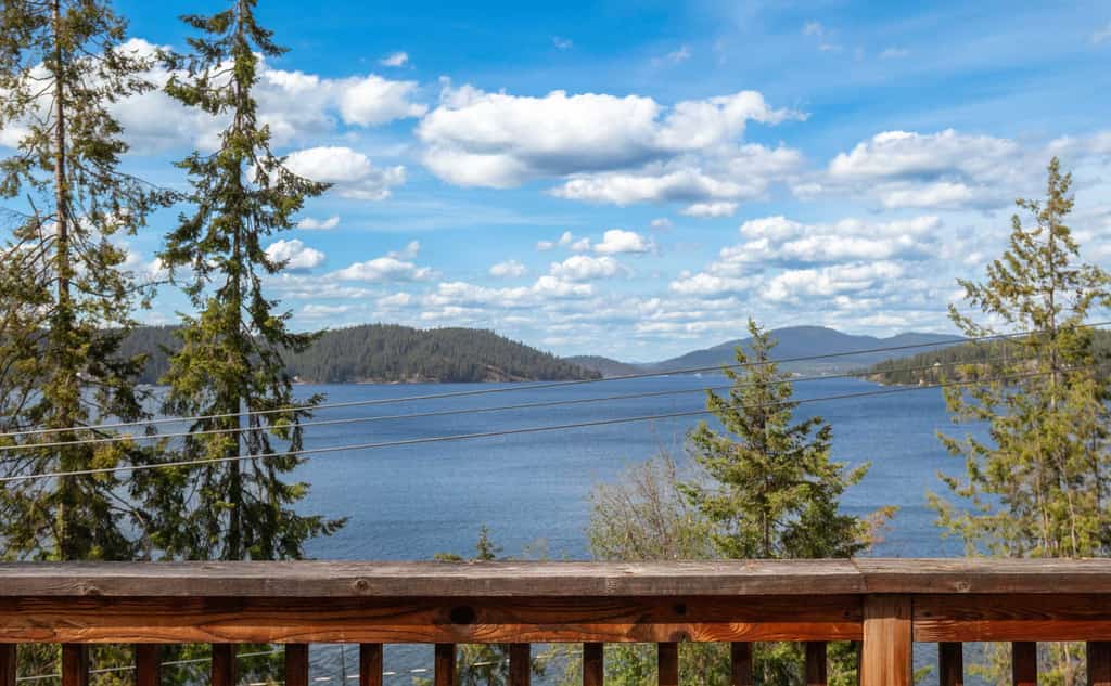 Wake Up to Spectacular Lake Views — Your Private Group Sanctuary at Lake Coeur d'Alene. This 4-bedroom, 3-bathroom home sleeps 12 across three stories with multiple living areas, purpose-built for multi-generational gatherings, extended family holidays, and friend groups. Dogs are absolutely welcome.