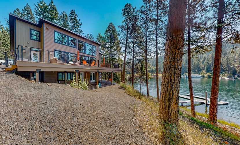 Escape to a luxurious lakefront retreat on a private point of Lake Coeur d’Alene. Enjoy stunning sunset views, direct shoreline access, a private dock, and an expansive deck with a grill and fire table. Inside, unwind in a beautifully designed 3-bedroom, 3-bathroom home featuring a gourmet kitchen, cozy fireplace, and inviting spaces for up to 8 guests. Peaceful, private, and perfect for unforgettable lake days.