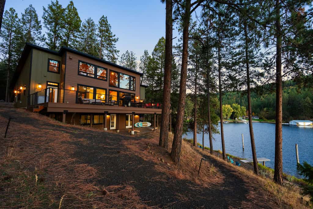 Escape to a luxurious lakefront retreat on a private point of Lake Coeur d’Alene. Enjoy stunning sunset views, direct shoreline access, a private dock, and an expansive deck with a grill and fire table. Inside, unwind in a beautifully designed 3-bedroom, 3-bathroom home featuring a gourmet kitchen, cozy fireplace, and inviting spaces for up to 8 guests. Peaceful, private, and perfect for unforgettable lake days.