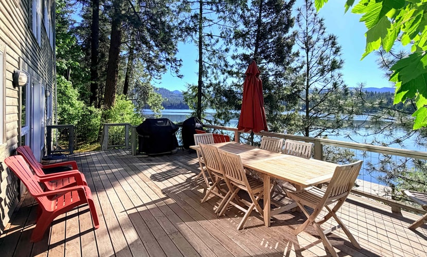 Wake up to breathtaking mountain and lake views at this stunning lakefront retreat on Hayden Lake's quiet western shore. With 3BR/3BA sleeping 8, a private dock, and a spacious deck made for lazy afternoons, this home is your escape from the everyday. Cozy up by the fireplace after a day on the water, or gather in the warm, open living space that makes every stay feel like home.