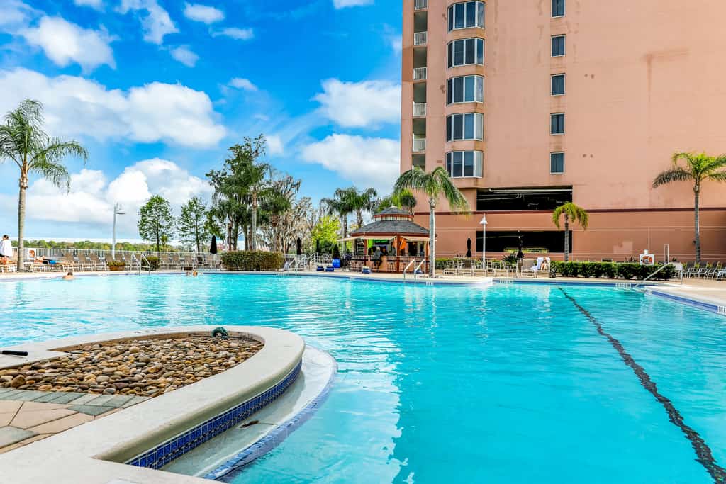 Unwind in a lakefront condo with AC, pool, hot tub & fitness center close to fun