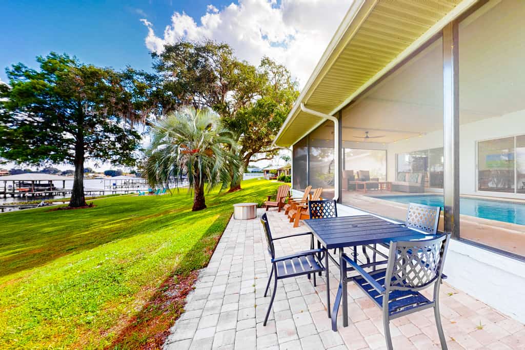 Renovated lakefront retreat with screened pool, private dock, patio, grill & W/D
