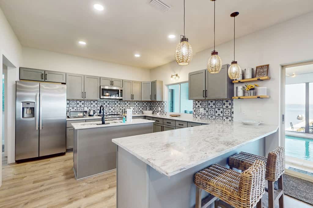 Renovated lakefront retreat with screened pool, private dock, patio, grill & W/D