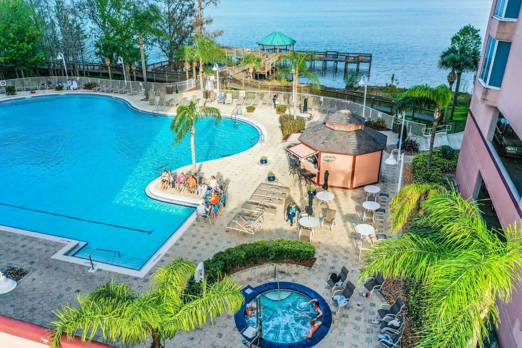 Relaxing lakefront condo near attractions with AC, hot tub, pool & lake view