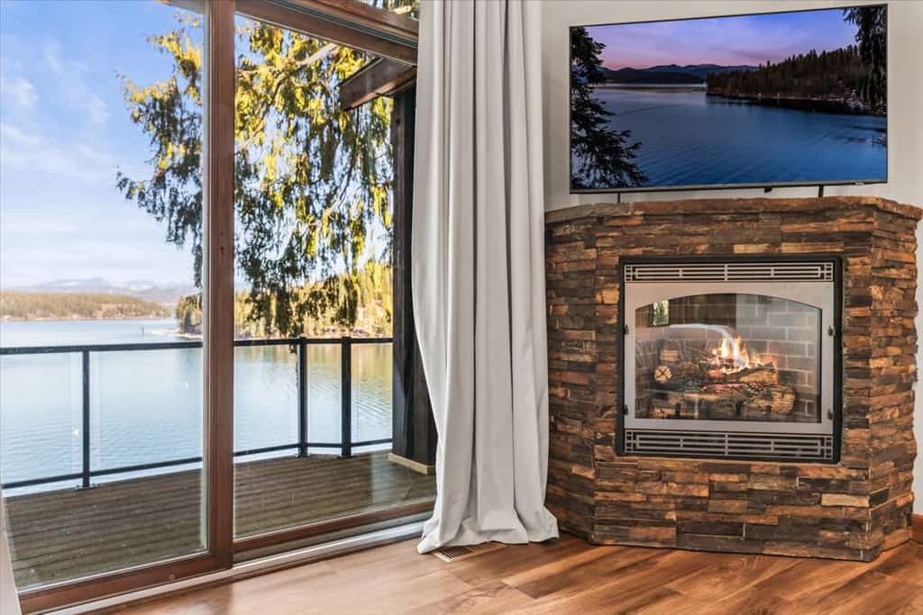 Lake mornings, mountain sunsets, and your private slice of Hayden Lake—bring the whole crew. Welcome to a 4-bedroom, 4-bath home designed for groups and families who want everyone fed, entertained, and happy under one roof. Sleeps 10 across four generously sized bedrooms, each with its own full bathroom. Hot tub with views of the water. Covered dock with 75 feet of deep waterfront access. Game room, movie theater room, sauna, and gym. Kayaks included—launch straight from your private dock. This is the home you book when the whole extended family is coming.