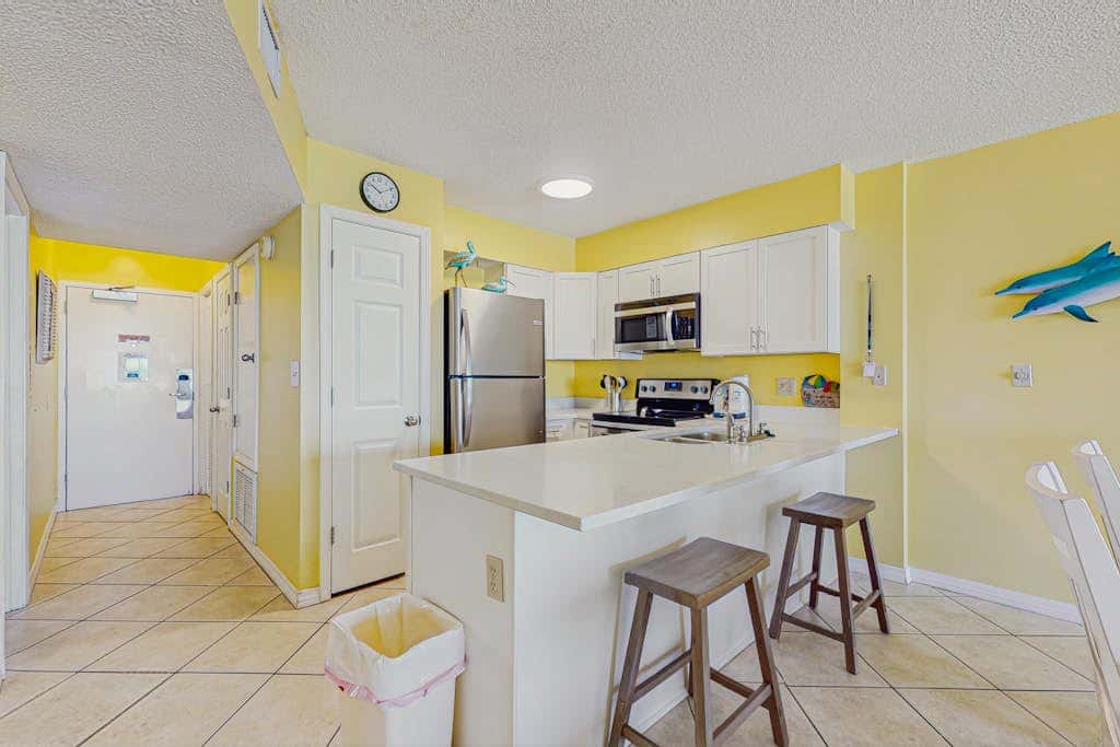 Beachfront condo with balcony, Gulf views, pools, gym, & game room at Plantation Palms