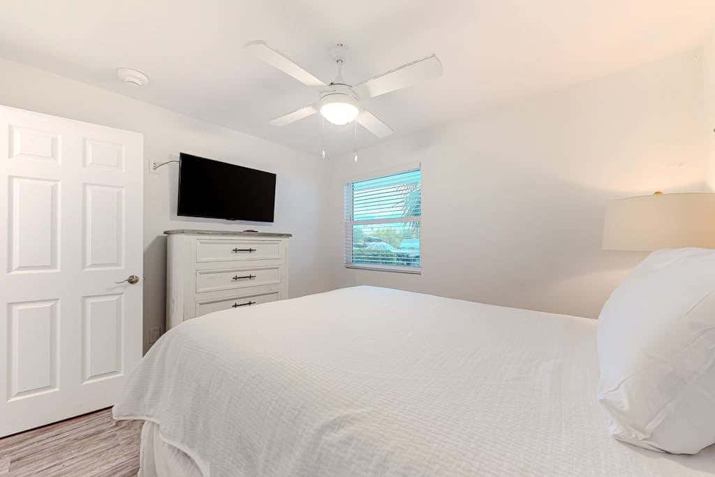 Coastal condo with open layout, nautical theme, smart TVs, beach access, & AC