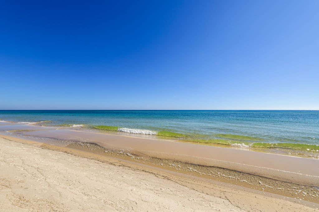 Beachfront condo with private balcony & shared pools, gym & sauna