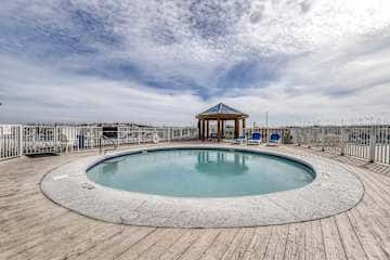 Family-friendly condo with a spacious living area, shared pools, & tennis courts