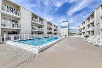 Family-friendly condo with a spacious living area, shared pools, & tennis courts
