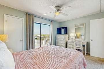 Family-friendly condo with a spacious living area, shared pools, & tennis courts