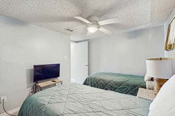 Family-friendly condo with a spacious living area, shared pools, & tennis courts