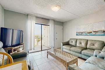 Family-friendly condo with a spacious living area, shared pools, & tennis courts