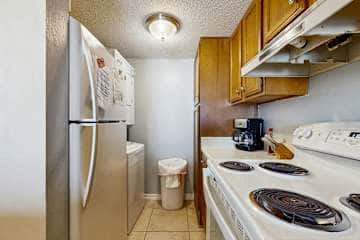 Family-friendly condo with a spacious living area, shared pools, & tennis courts