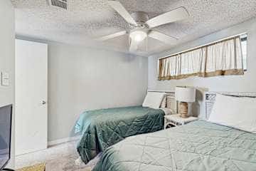 Family-friendly condo with a spacious living area, shared pools, & tennis courts