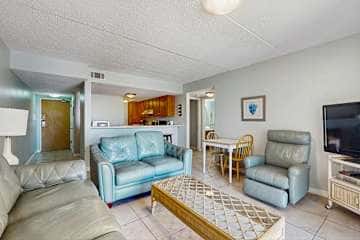 Family-friendly condo with a spacious living area, shared pools, & tennis courts