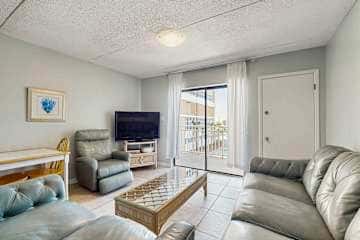 Family-friendly condo with a spacious living area, shared pools, & tennis courts