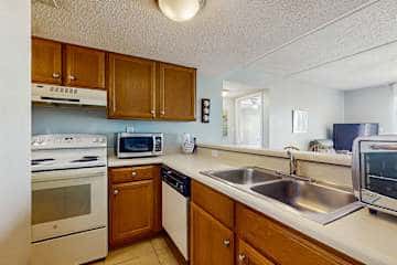 Family-friendly condo with a spacious living area, shared pools, & tennis courts