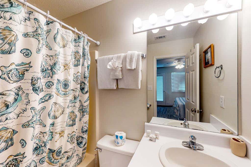 Gulf view home with two-level deck, beach access & shared pools, hot tub, gym