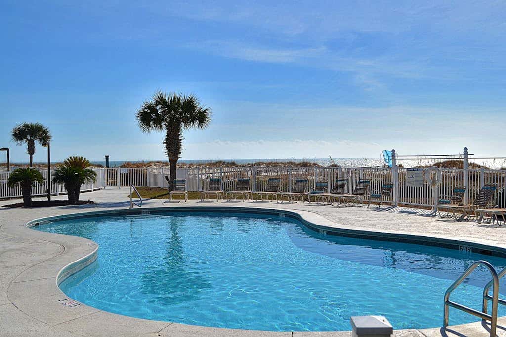 Oceanfront condo with Gulf-view balcony, beach access, pool, WiFi, & central AC