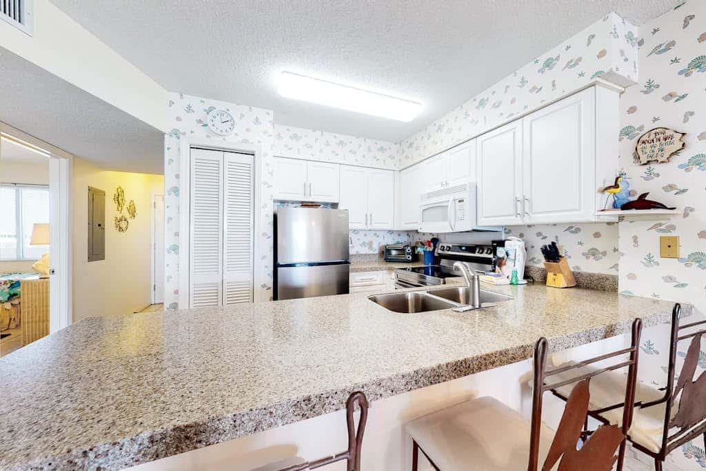 Oceanfront condo with Gulf-view balcony, beach access, pool, WiFi, & central AC