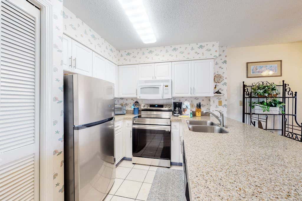 Oceanfront condo with Gulf-view balcony, beach access, pool, WiFi, & central AC
