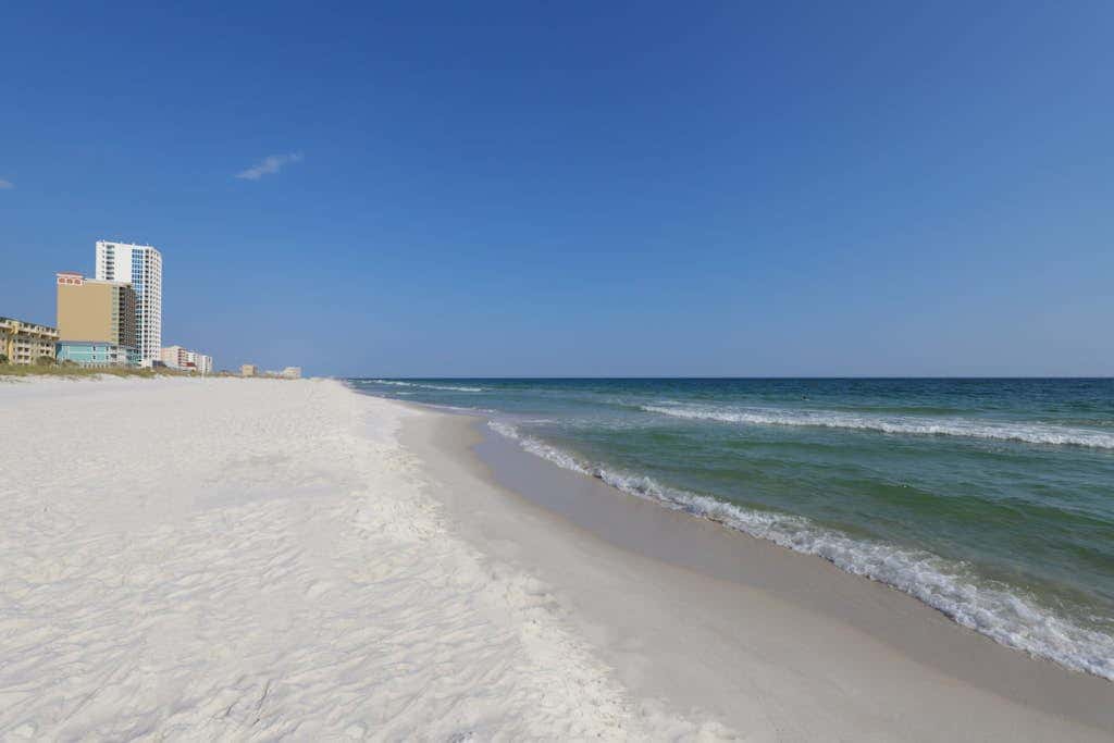 Waterfront condo with a furnished balcony, peek-a-boo Gulf views, & shared pools